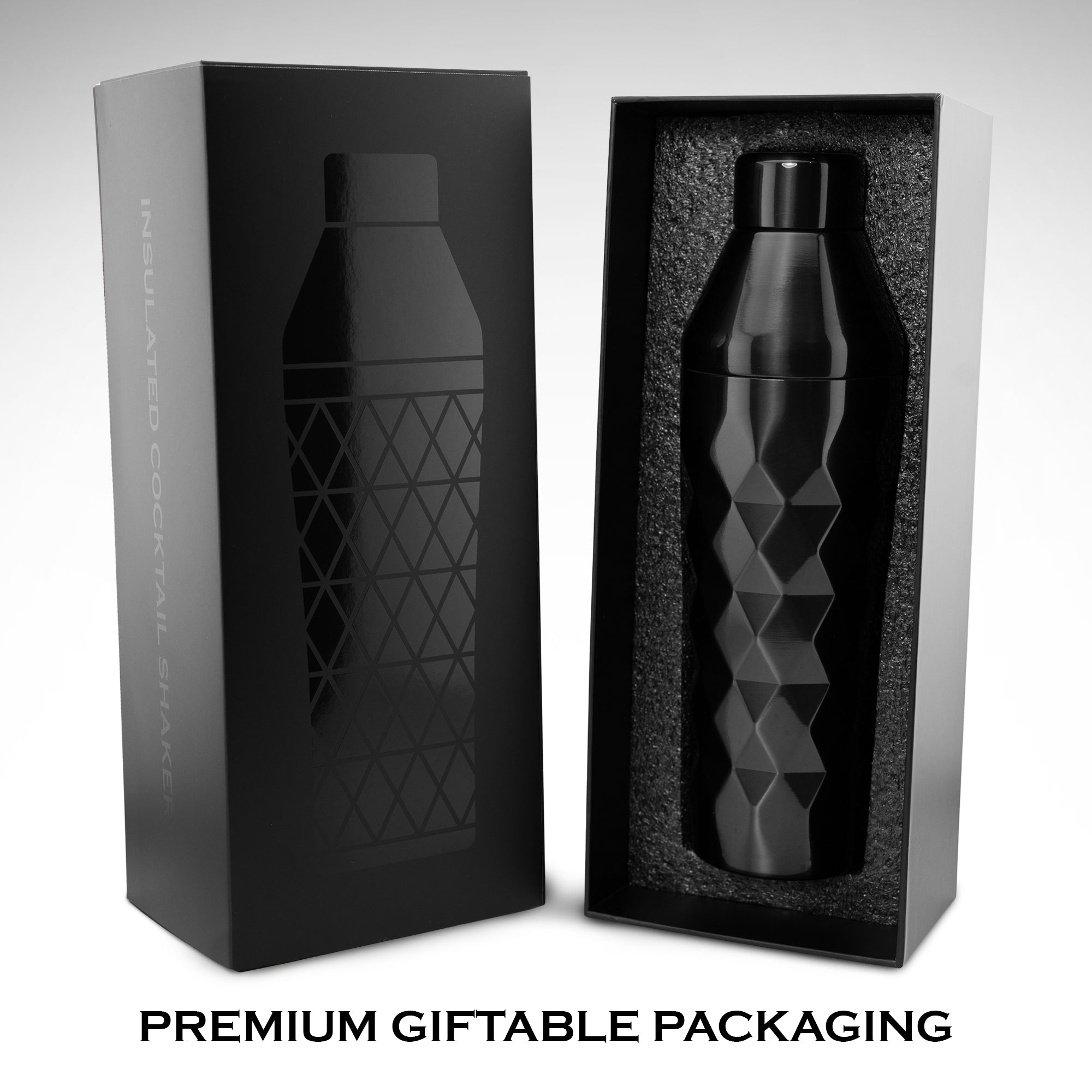 Black insulated cocktail shaker with geometric pattern in premium gift packaging on a light gray background.