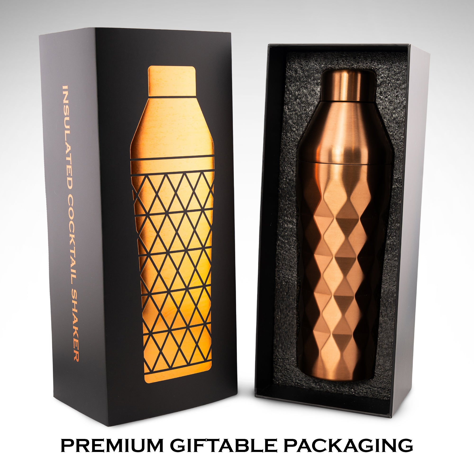 Copper cocktail shaker with geometric pattern in premium gift packaging in front of white background